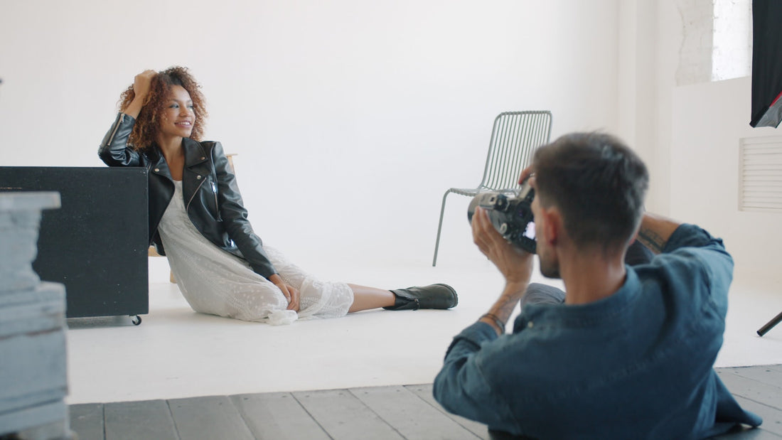 A photographer shooting a model on a fashion editorial set, the kind of placement fashion PR earns